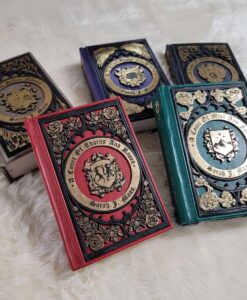 A Court of Thorns and Roses leather bound set. Each book is a different color leather with golden wood filigree on each cover.